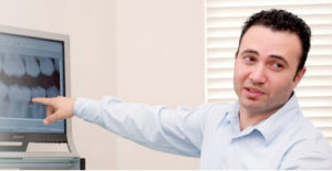 Dentist explaining an X-ray to patient.