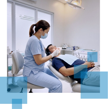Dental professional assisting a patient in a modern dental clinic.